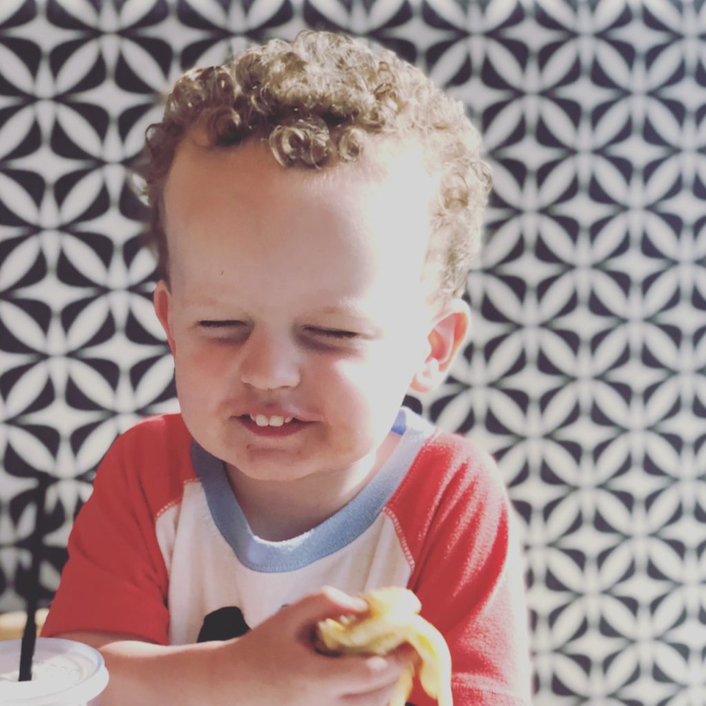 Curly haired toddler smiling pajamas