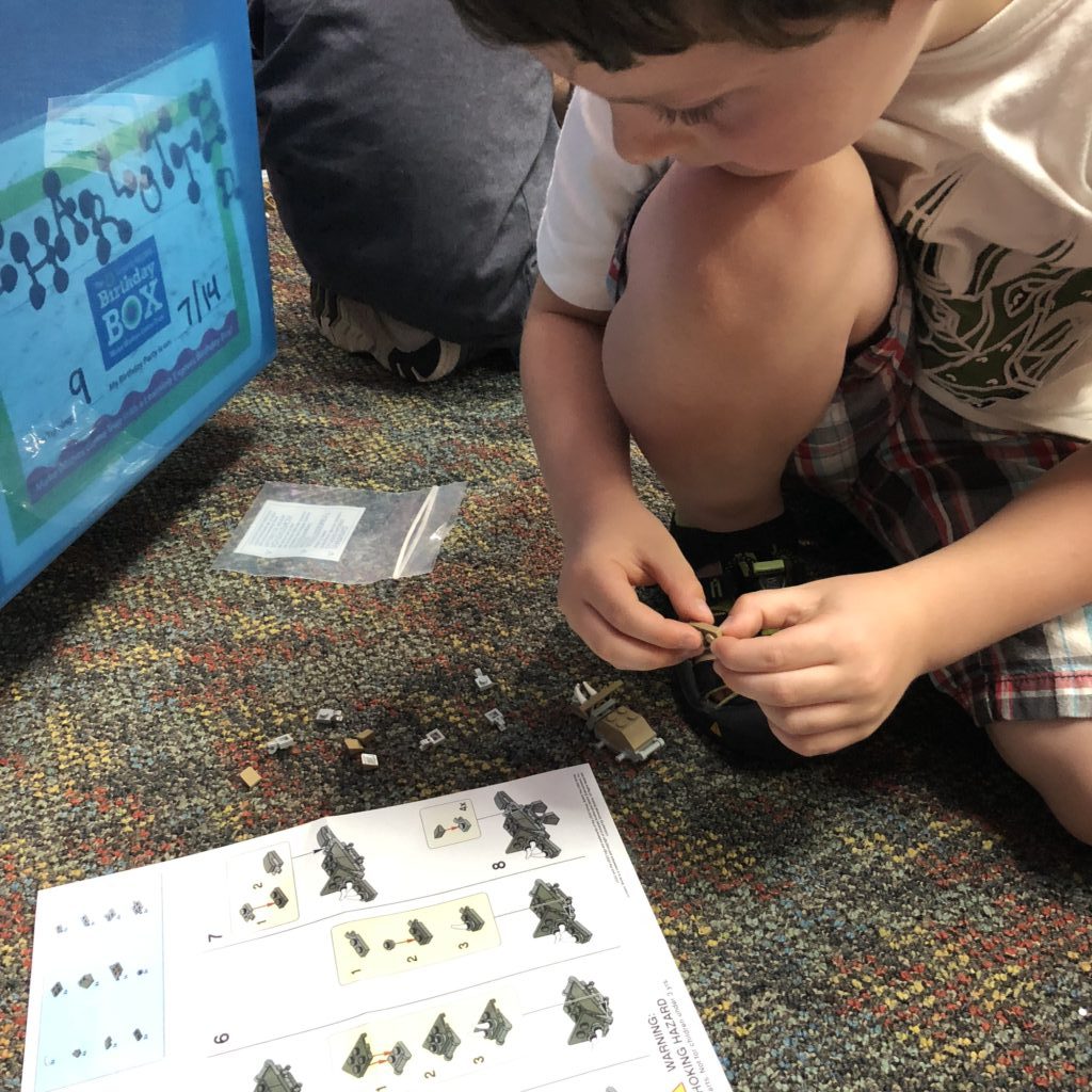 Boy building LEGOS instructions
