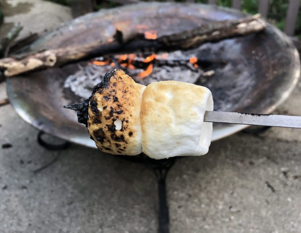 Backyard campfire fire pit roasted marshallows golden toasted on skewer