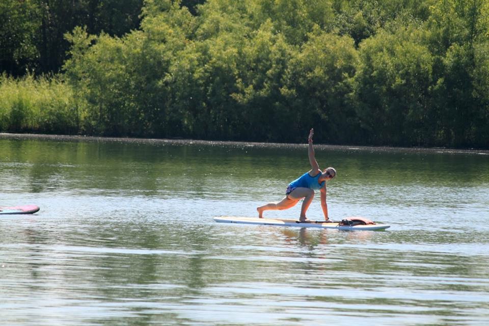 Standup Paddleboard Yoga Supine Twist Lake background