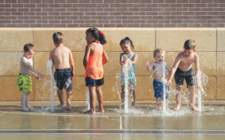 Summer Bucket List kids splashing in fountain