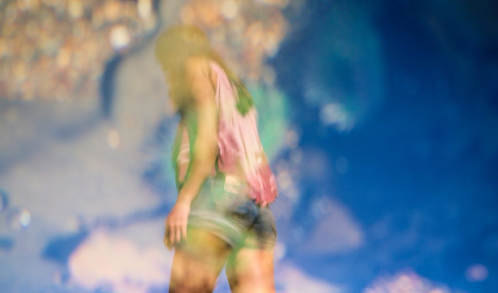 Self-image summer body woman wearing shorts against sky background