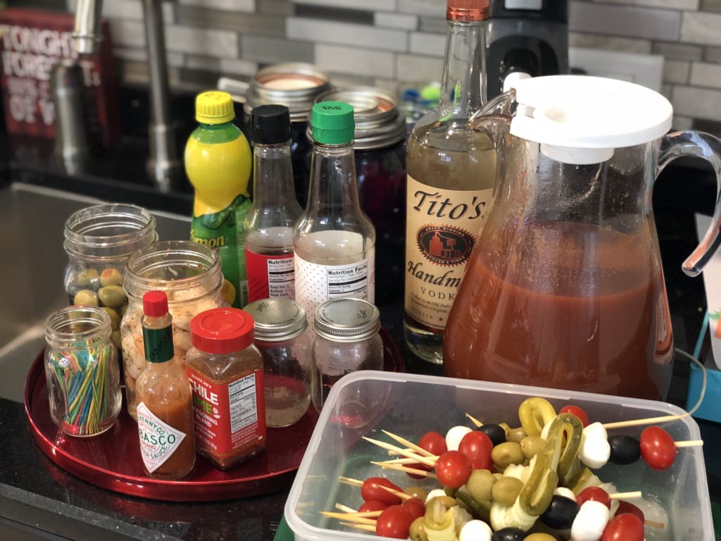 Be everyone's favorite brunch guest with this easy portable bring-your-own Bloody Mary bar with loaded skewers and best homemade Bloody Mary recipe #bloodymary #brunchcocktails #sundaybrunch