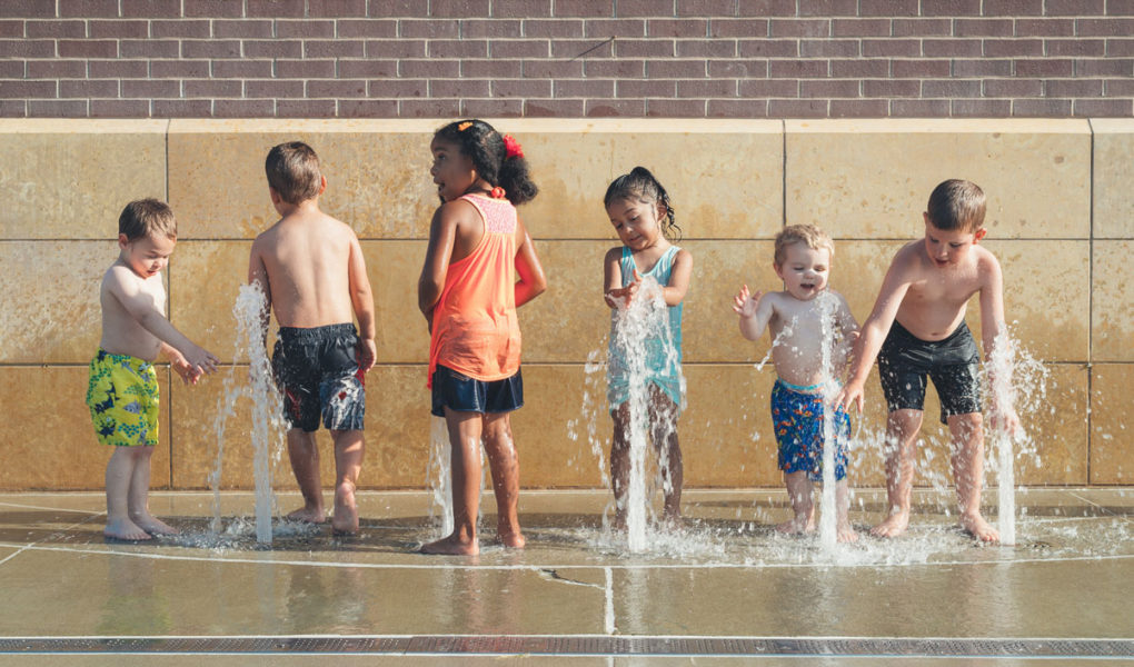 Summer Bucket List kids splashing in fountain