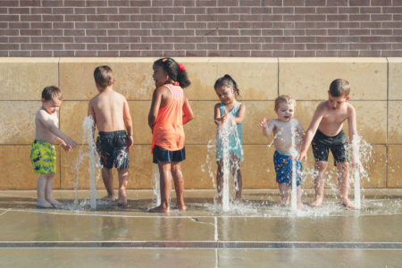 Summer Bucket List kids splashing in fountain