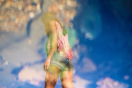 Self-image summer body woman wearing shorts against sky background
