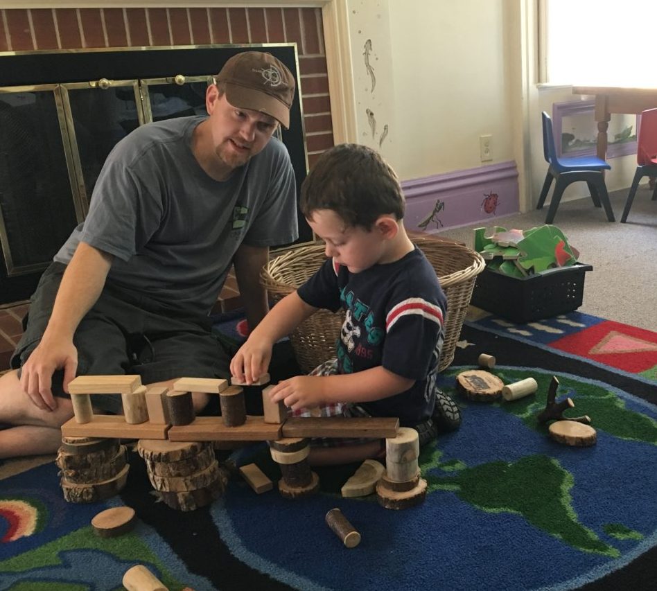 Indoor historical home children's center father and son playing blocks
