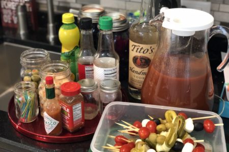 Be everyone's favorite brunch guest with this easy portable bring-your-own Bloody Mary bar with loaded skewers and best homemade Bloody Mary recipe #bloodymary #brunchcocktails #sundaybrunch